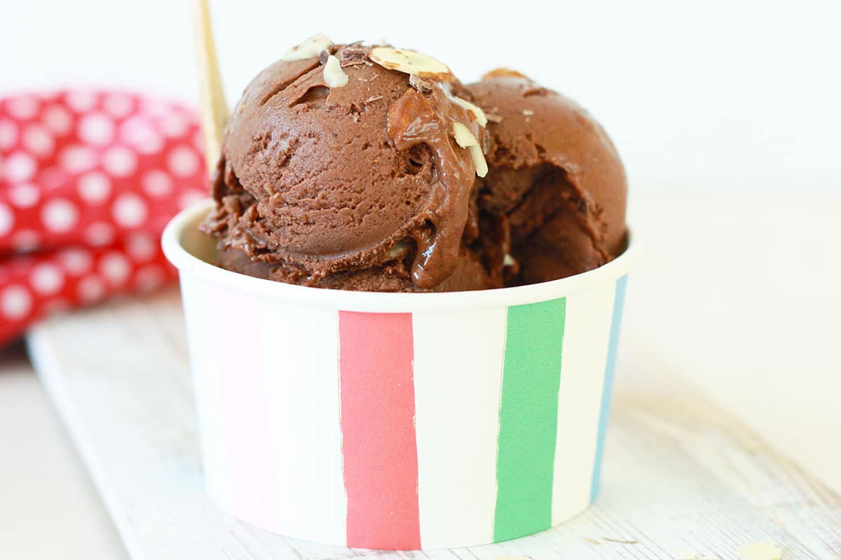 chocolate banana ice cream in a striped paper bowl