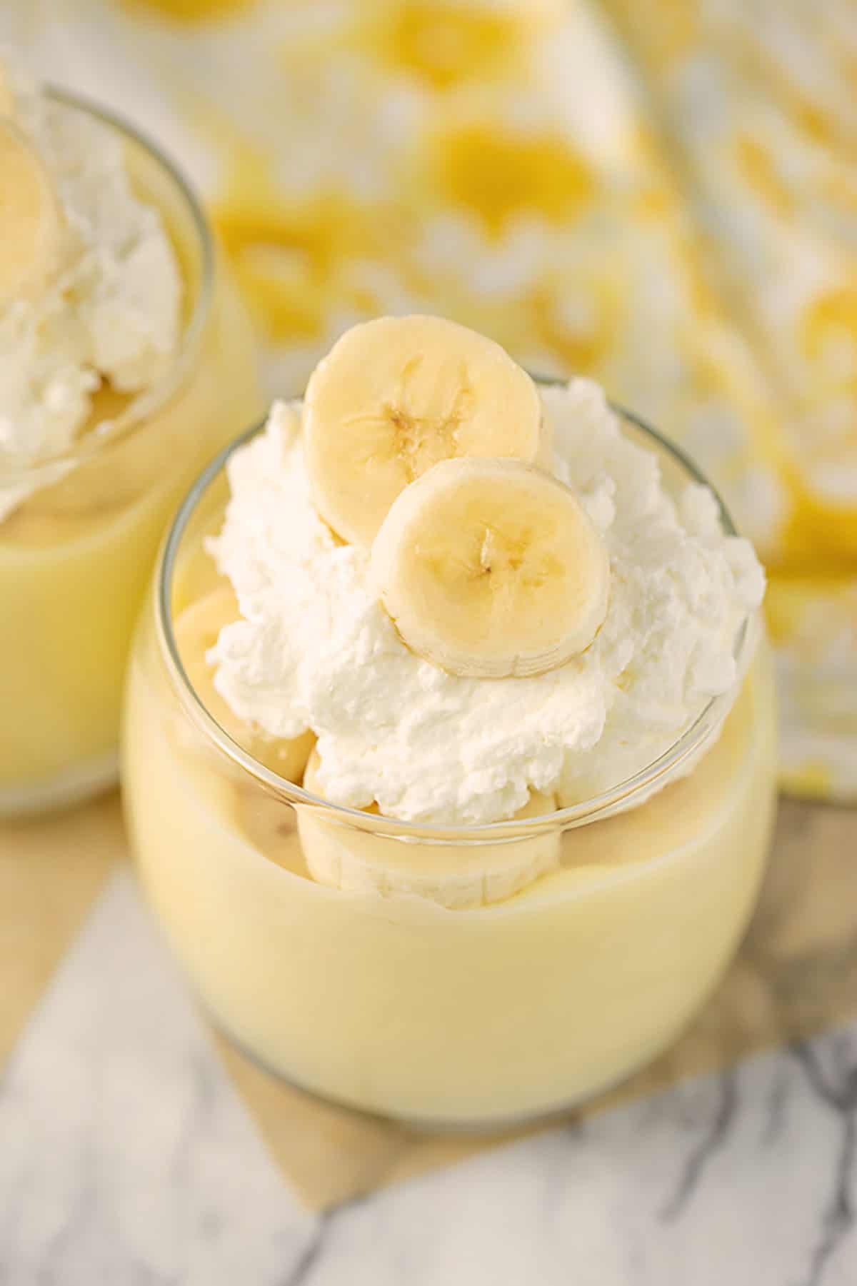 creamy homemade banana pudding layered with fresh bananas and whip cream on top