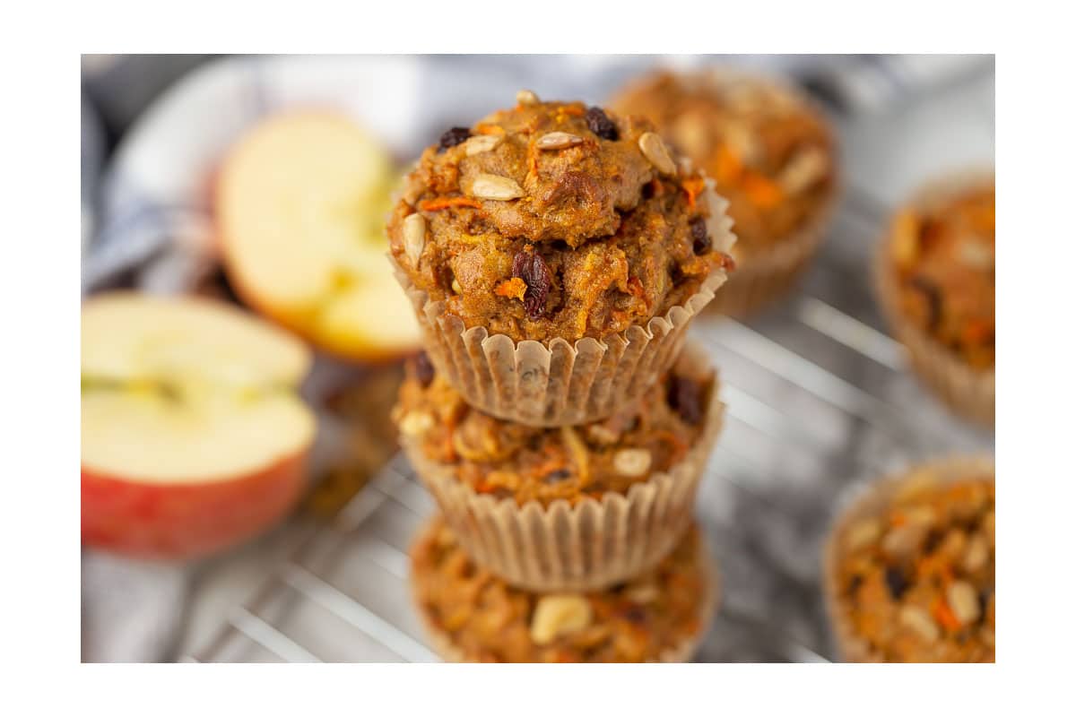 morning glory muffins stacked on a cooling rack