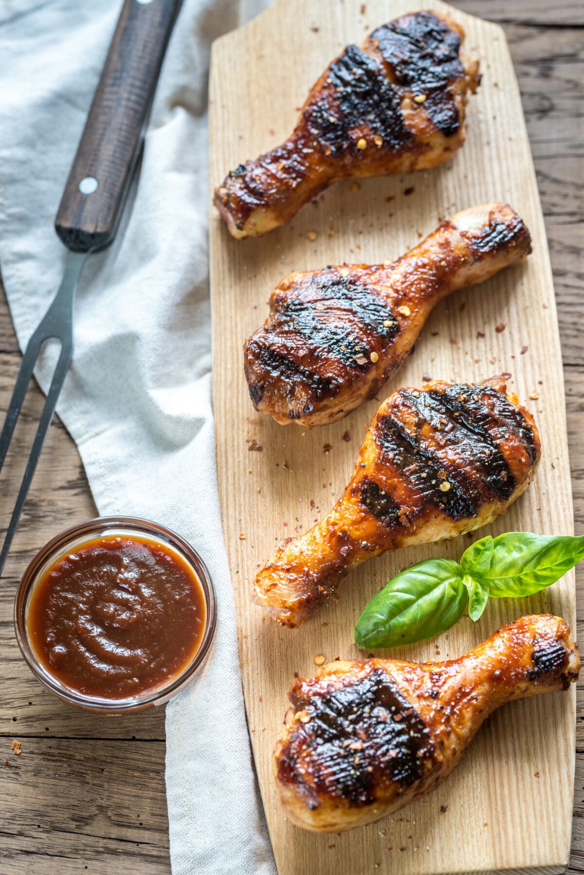 grilled chicken drumsticks with a coconut lime marinade on a wooden cutting board