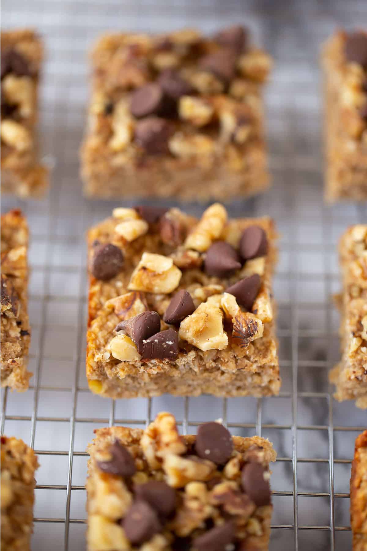 3 ingredient peanut butter banana snack bars on a cooling rack cut into squares. 