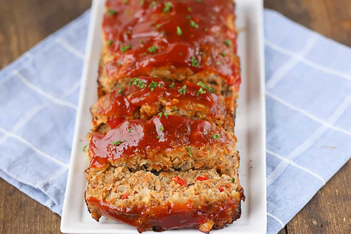 healthy turkey meatloaf with slices on a white platter