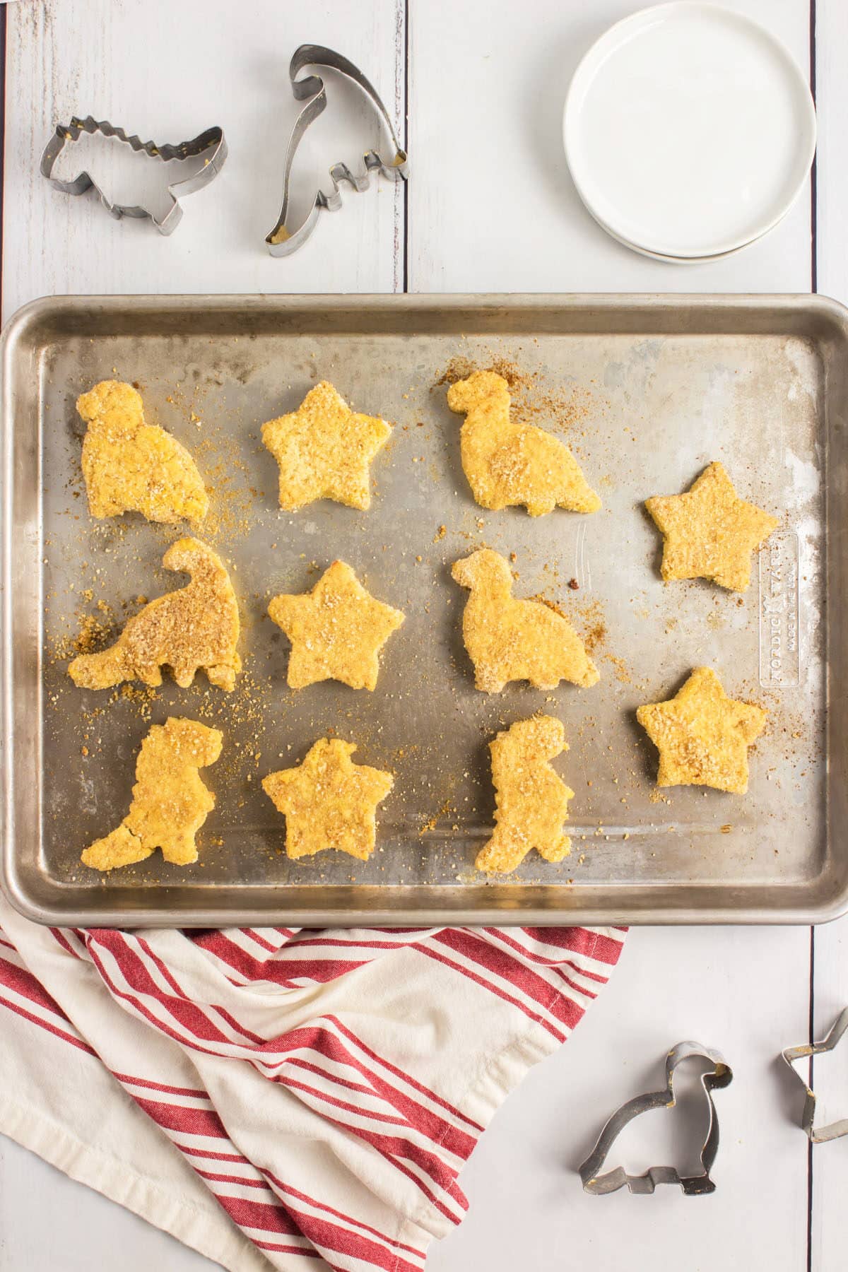 The Best Homemade Chicken Nuggets 8 homemade chicken nuggets in shapes on a baking tray