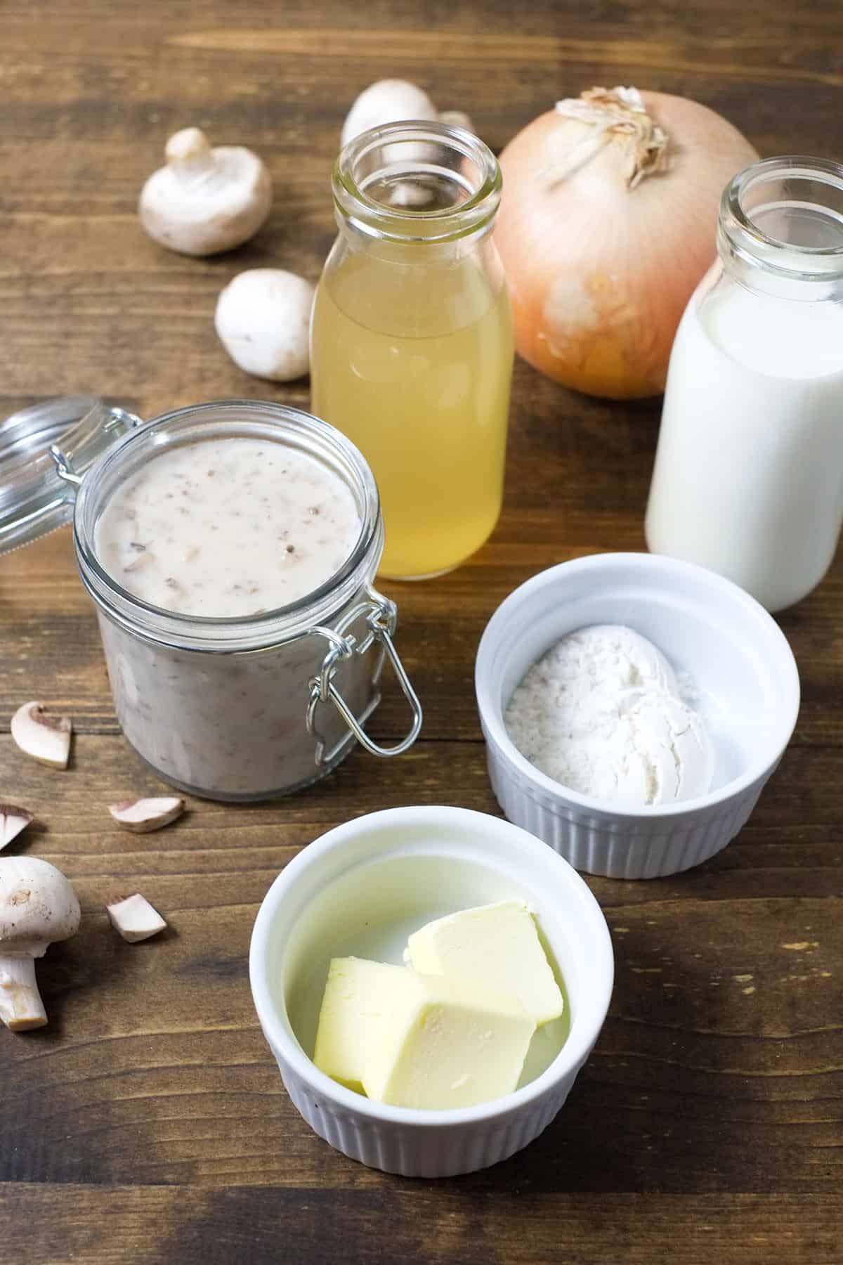 ingredients for cream of mushroom soup, chicken broth, milk, flour, butter, mushrooms, onion