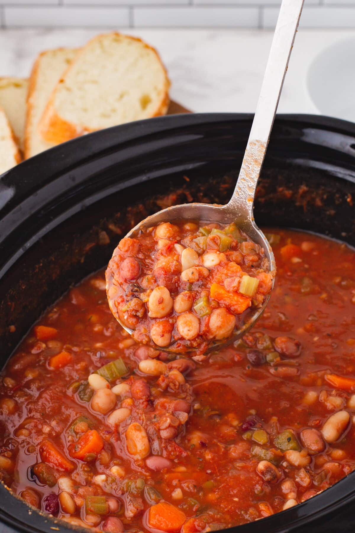 15 bean soup in the crockpot with a ladle