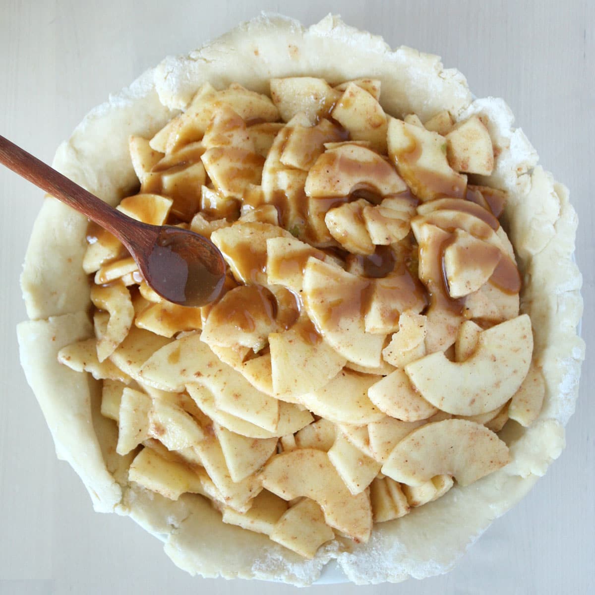 apple slices tossed in cinnamon sugar in a pie crust and drizzled with caramel sauce