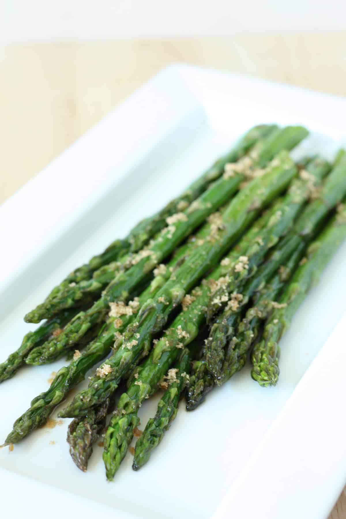 roasted asparagus on a white plate