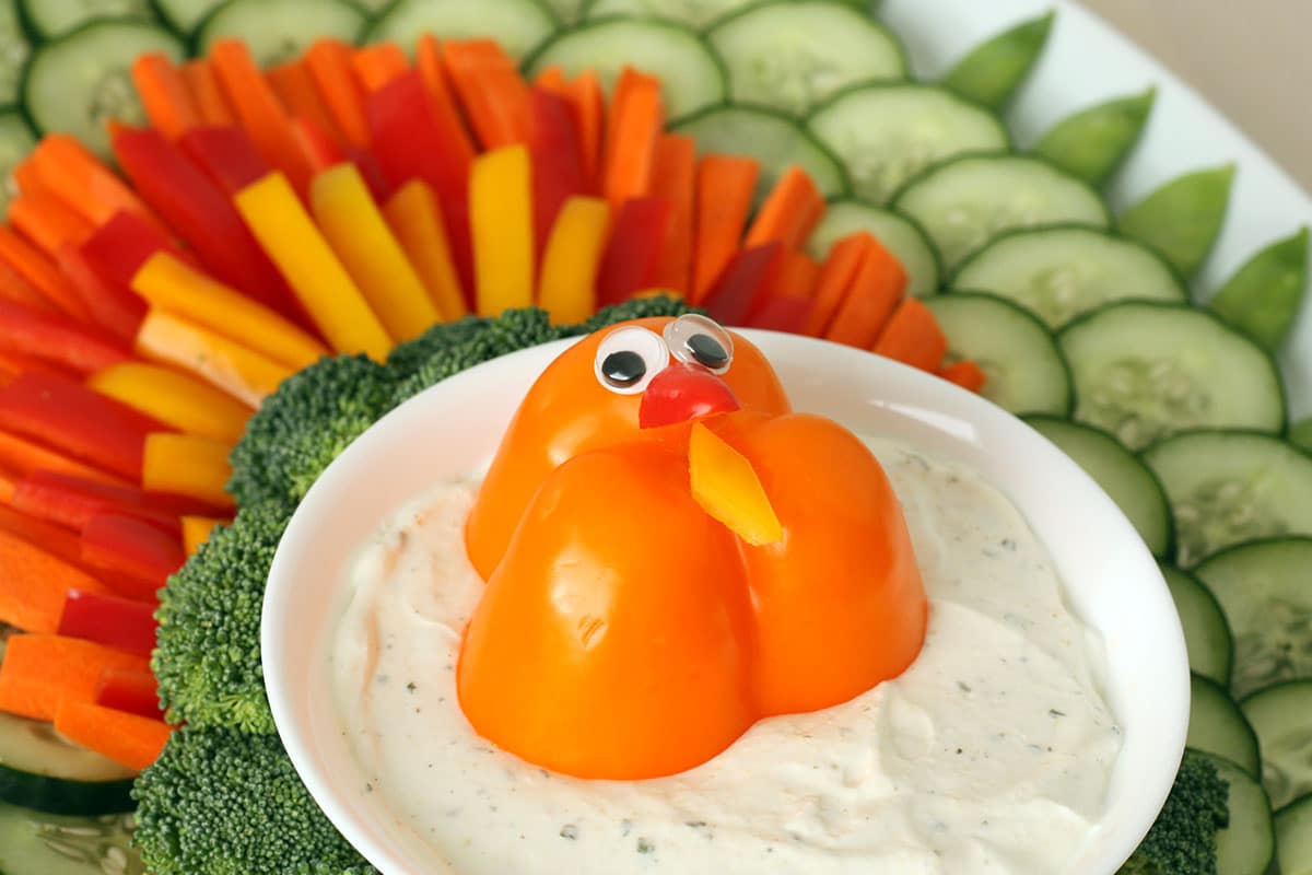 a bowl of homemade ranch dip topped with a bell pepper turkey