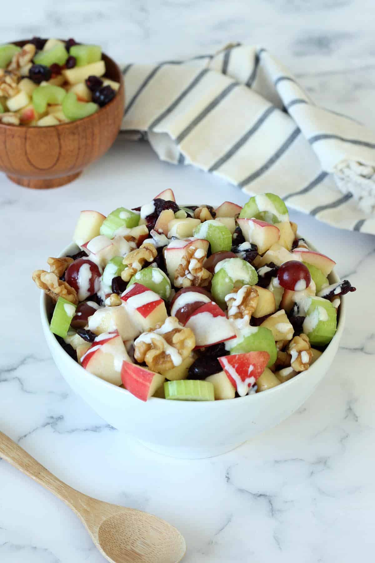 a bowl of waldorf salad recipe drizzled with greek yogurt dressing
