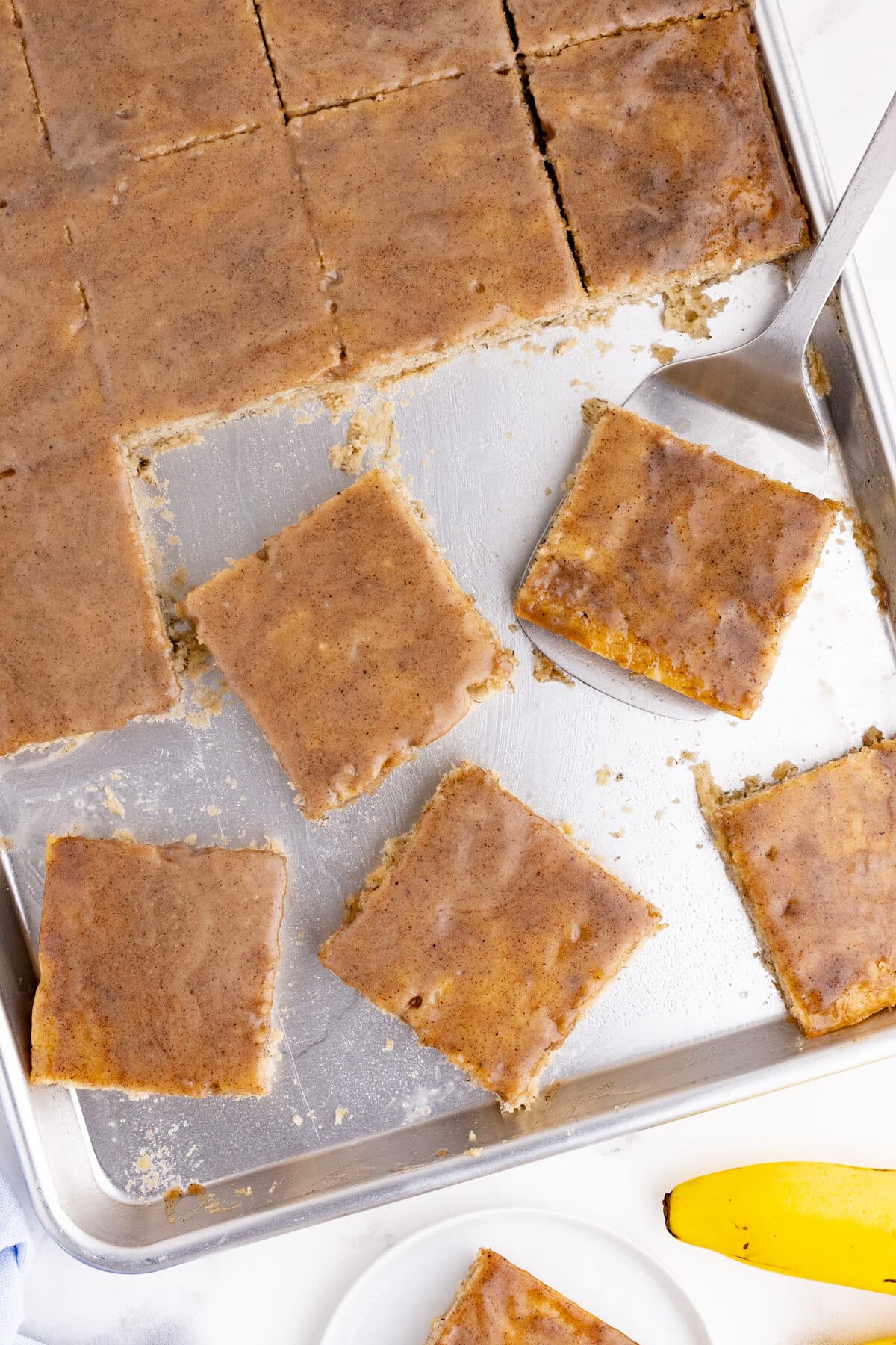 banana cake cut into pieces on a sheet pan