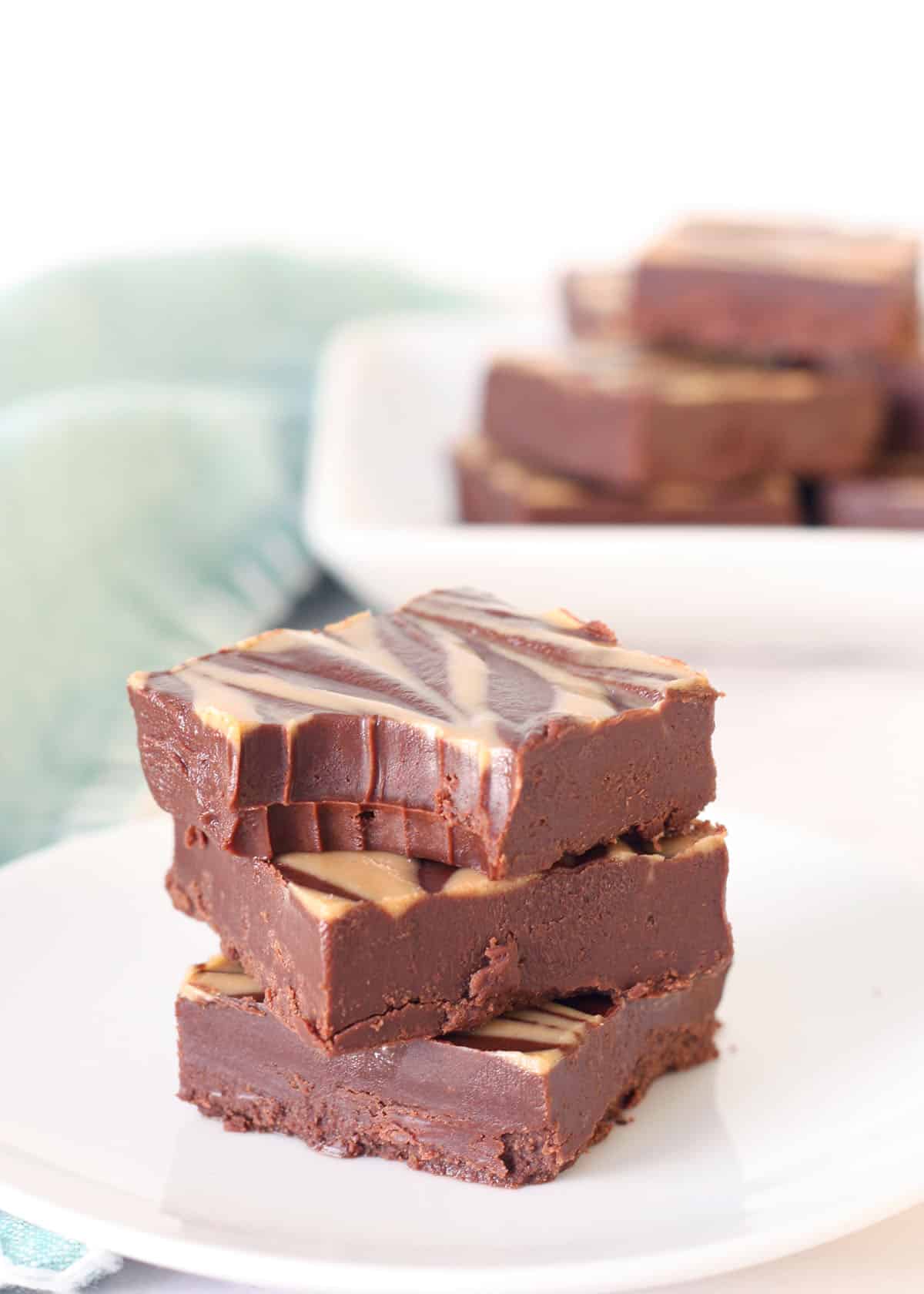 healthy peanut butter fudge stacked on a white plate