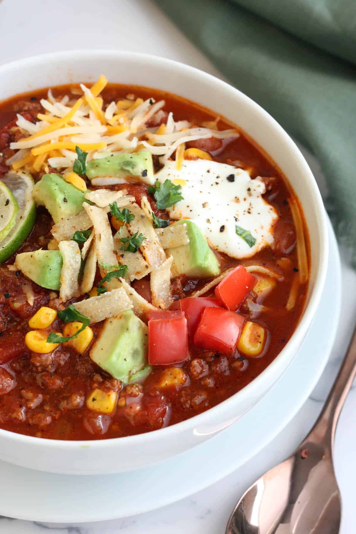 A bowl of the best taco soup ever in a white bowl