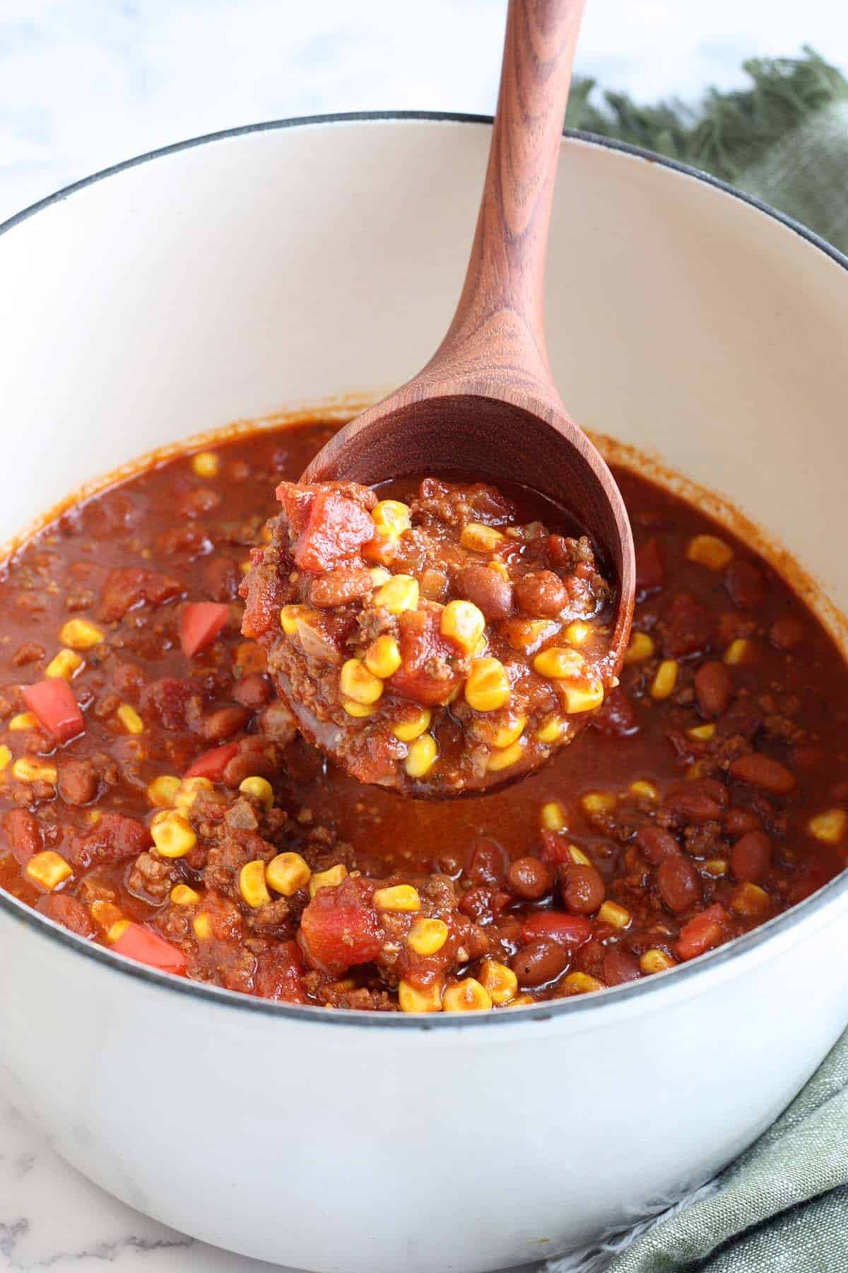 A ladle full of taco soup in a soup pot