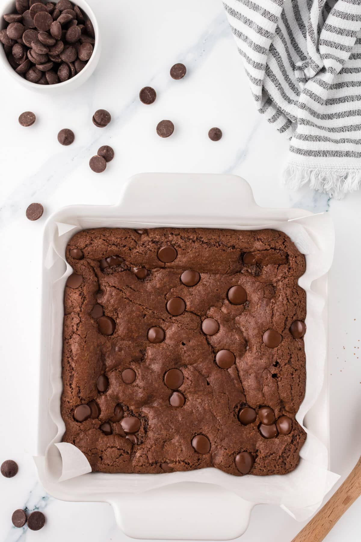 chocolate chip brownies in a white baking dish