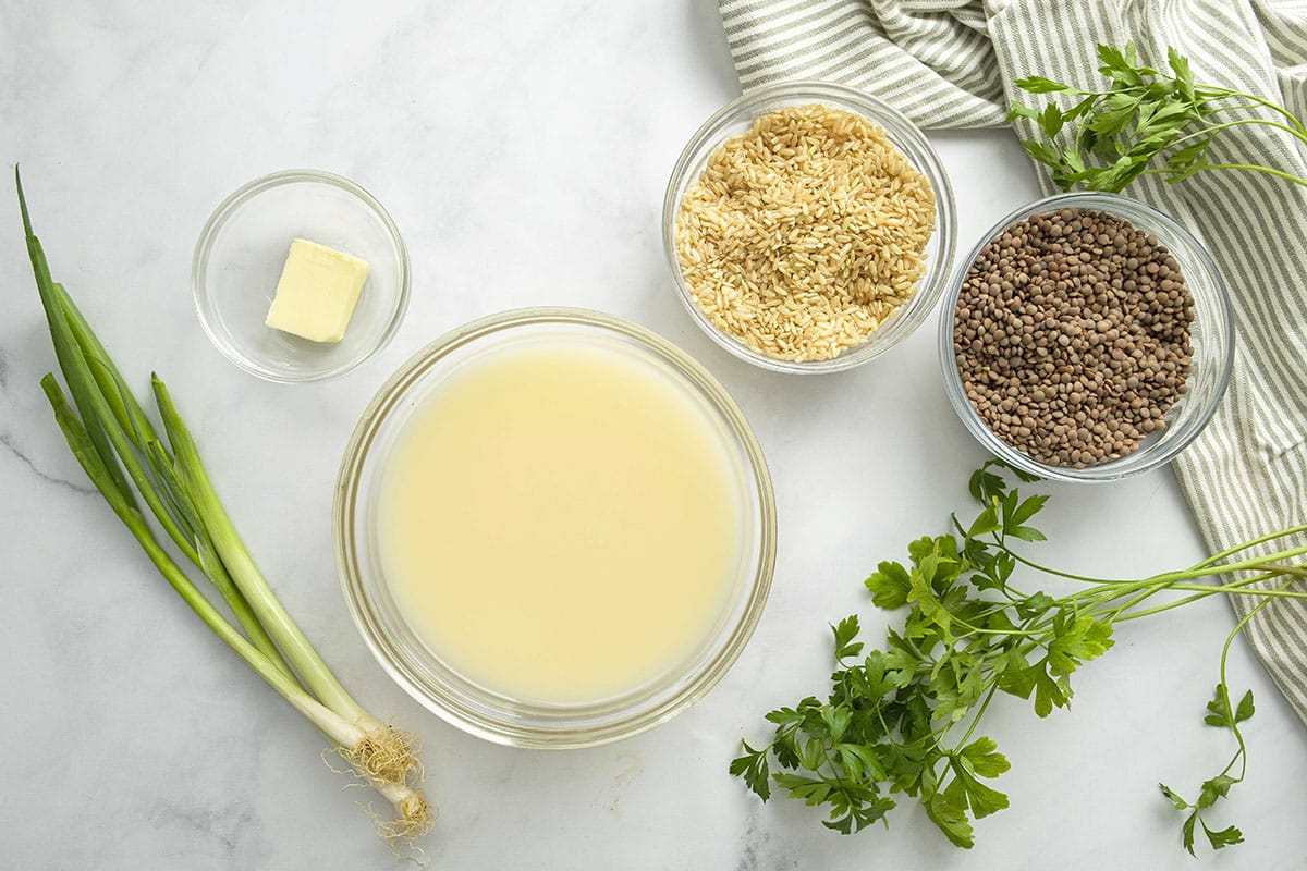 ingredients for lentils and rice: chicken broth, butter, brown rice, lentils, parsley, green onion