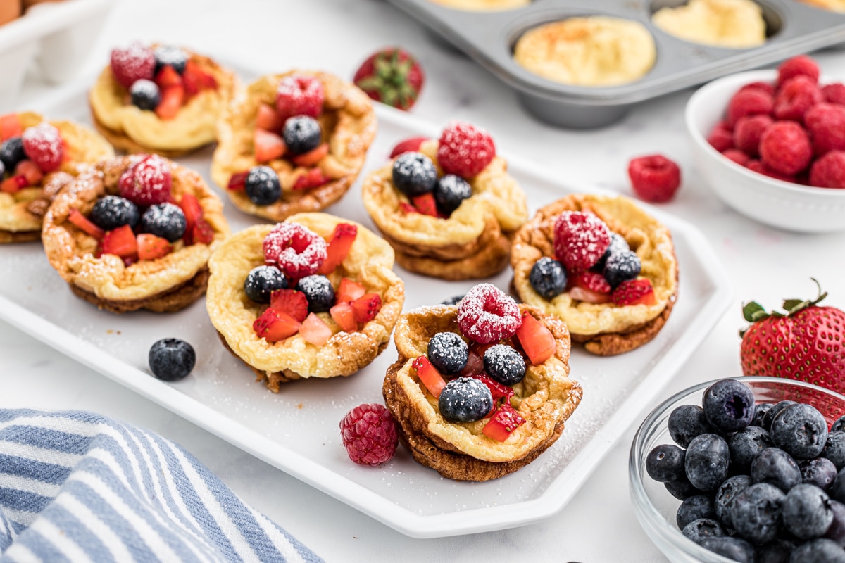 Homemade popovers on white tray with berries