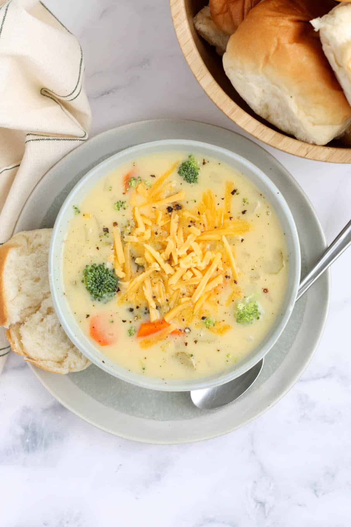 overhead shot of crockpot vegetable soup topped with shredded cheese