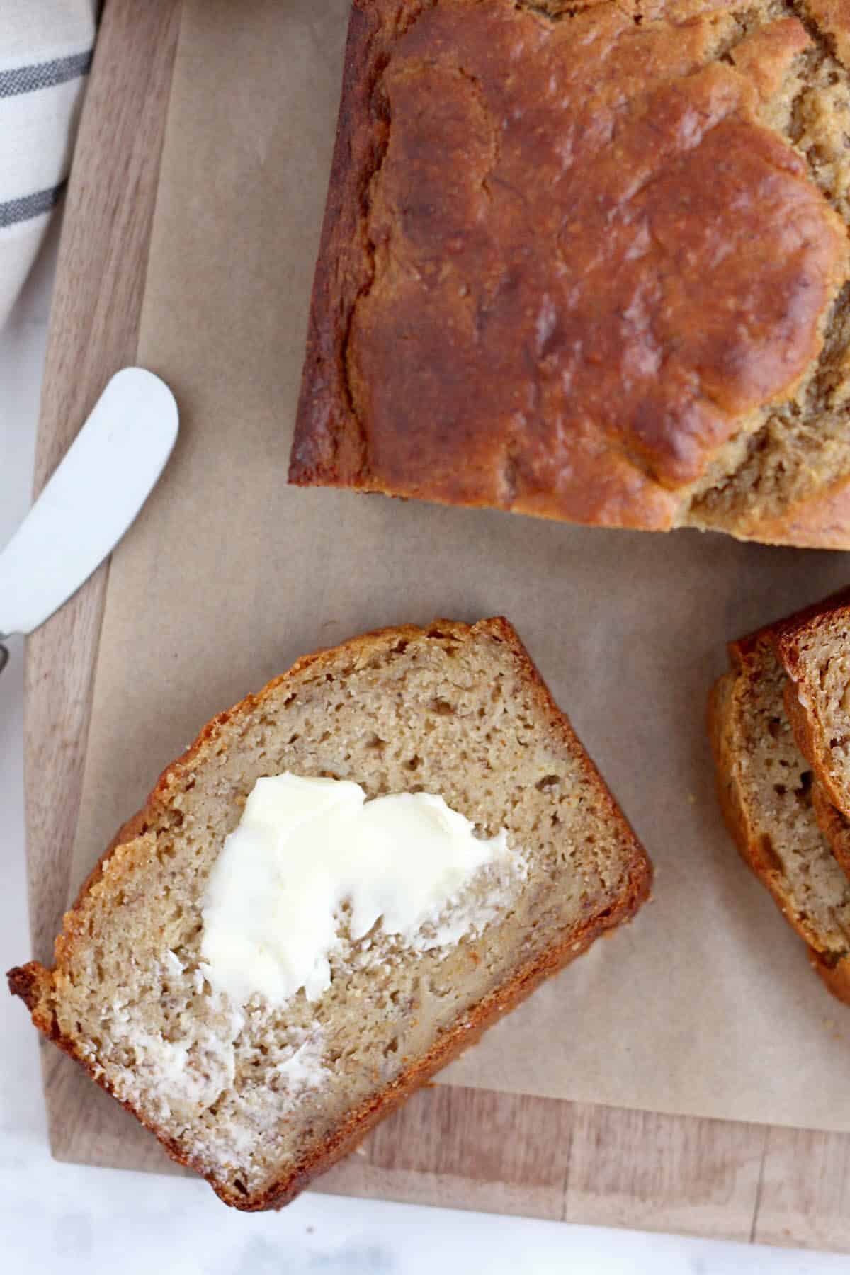 Healthy Banana Bread Recipe 8 a slice of healthy banana bread with a smear of butter