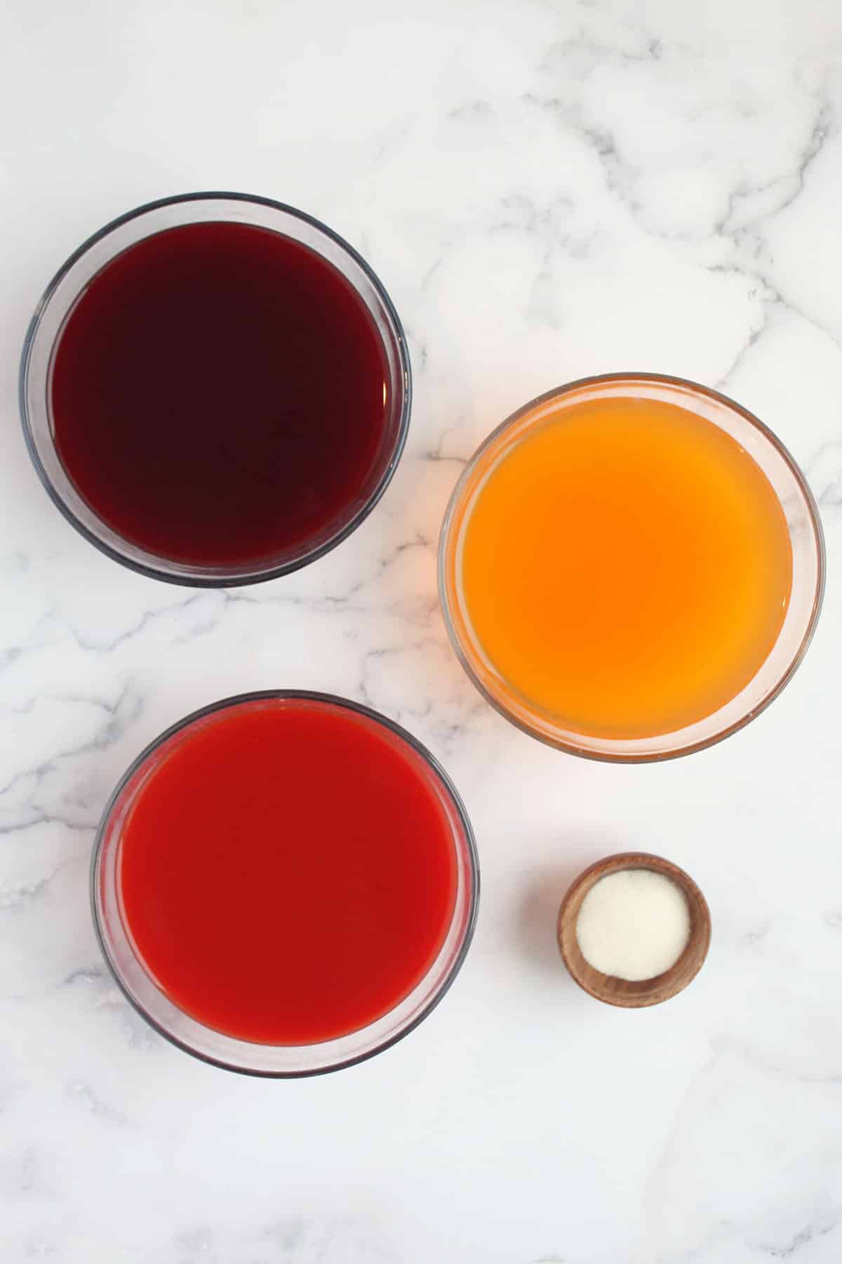 bowls of fruit juice for homemade jelly