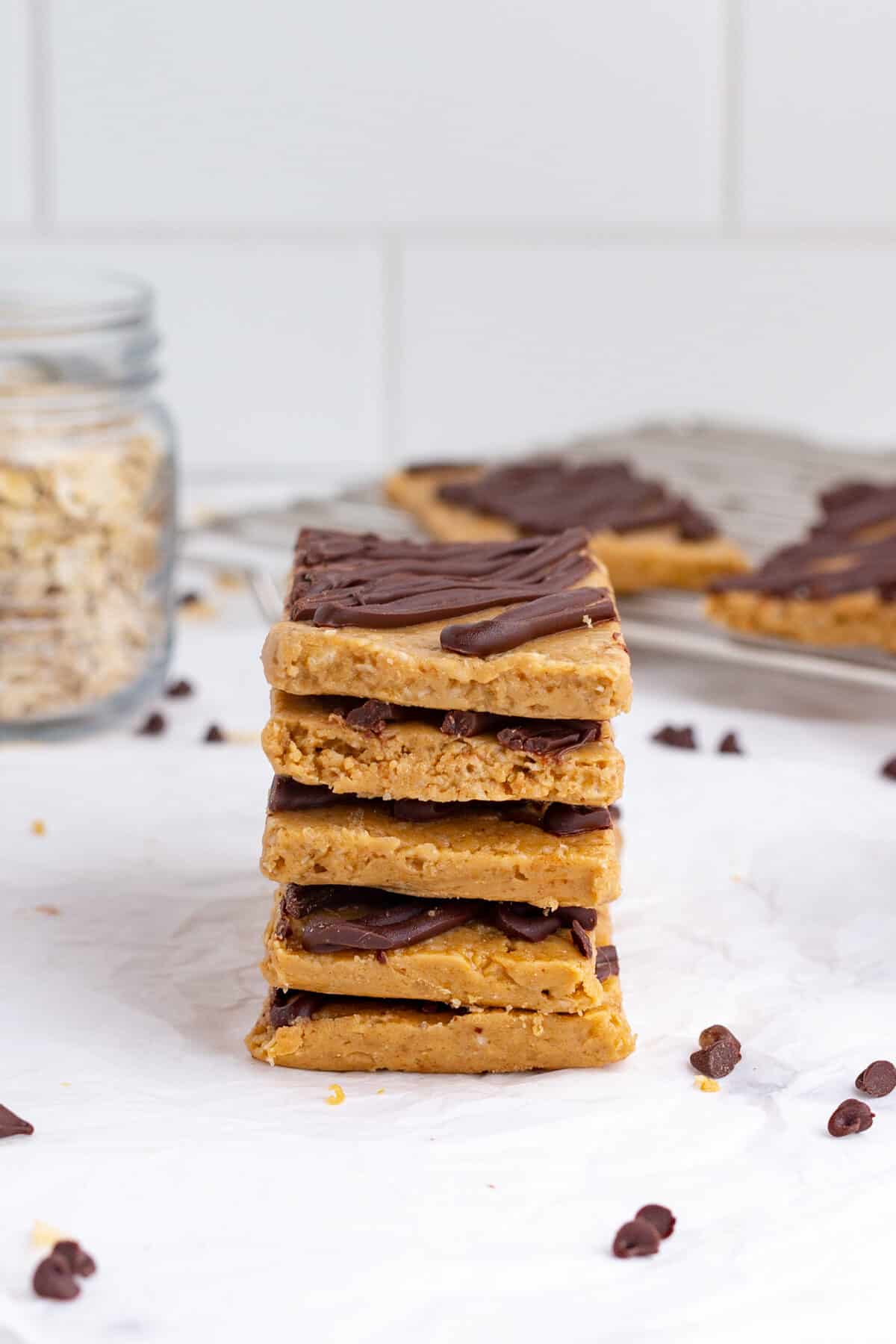 a stack of homemade protein bars drizzled with chocolate