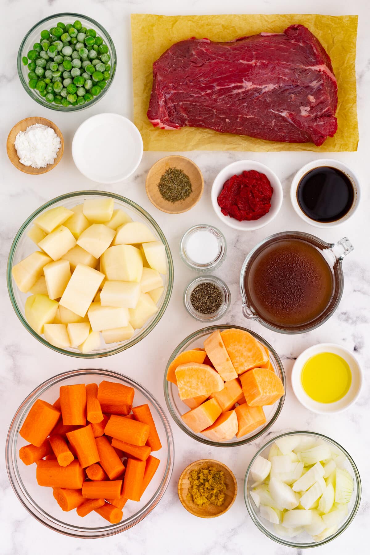 ingredients needed for beef stew: chuck roast, thyme, tomato paste, worcestershire sauce, salt and pepper, beef broth, potatoes, carrots, sweet potatoes and green peas