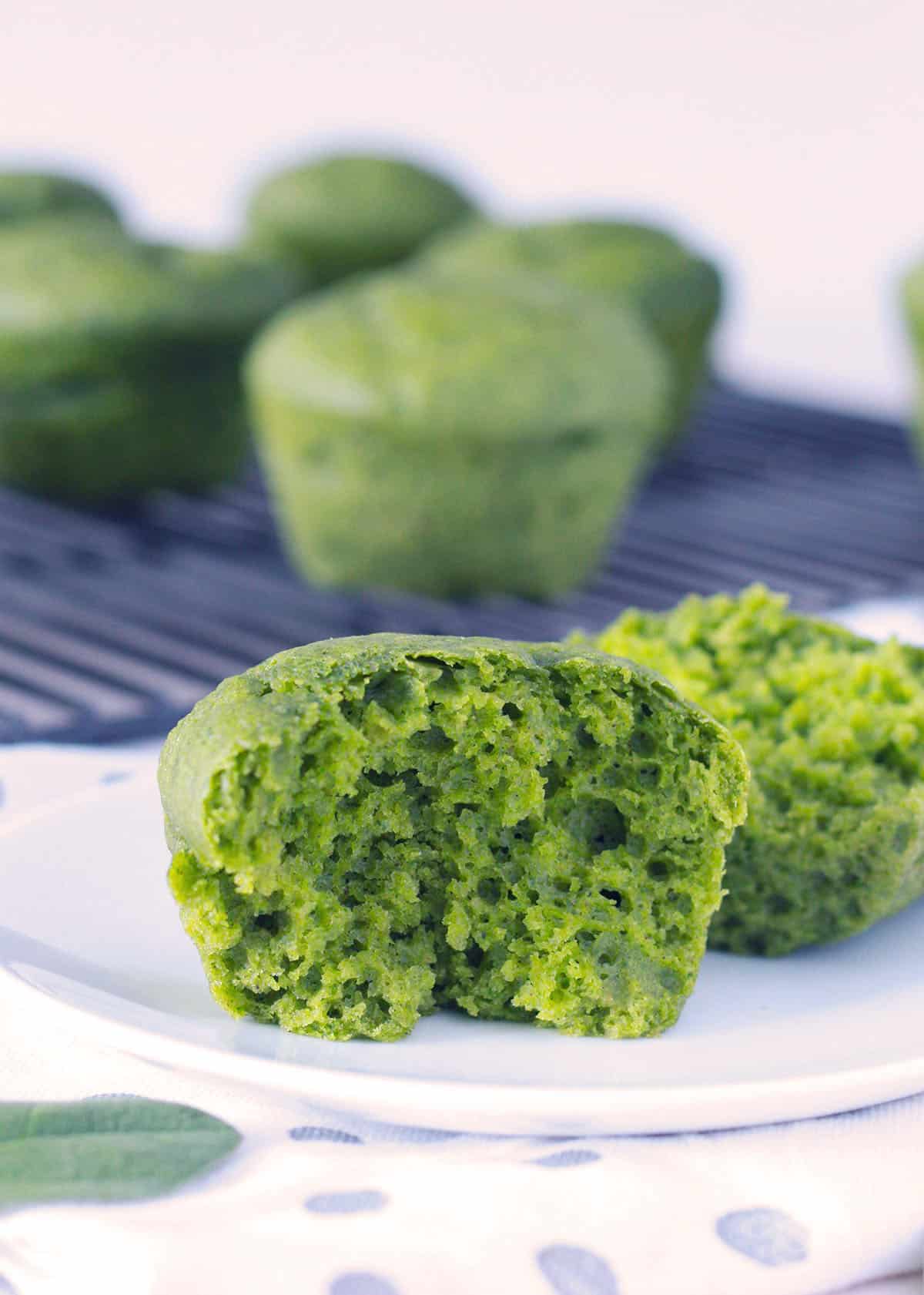 view of the inside of spinach muffin on a white plate