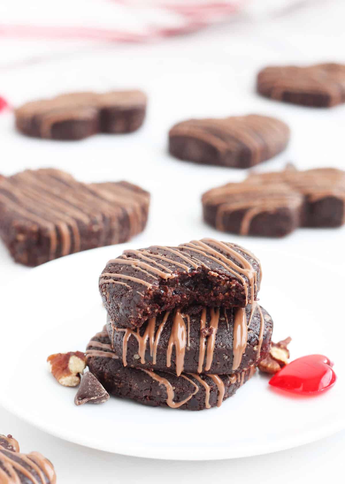 homemade chocolate rx bars shaped into hearts and stacked on a plate