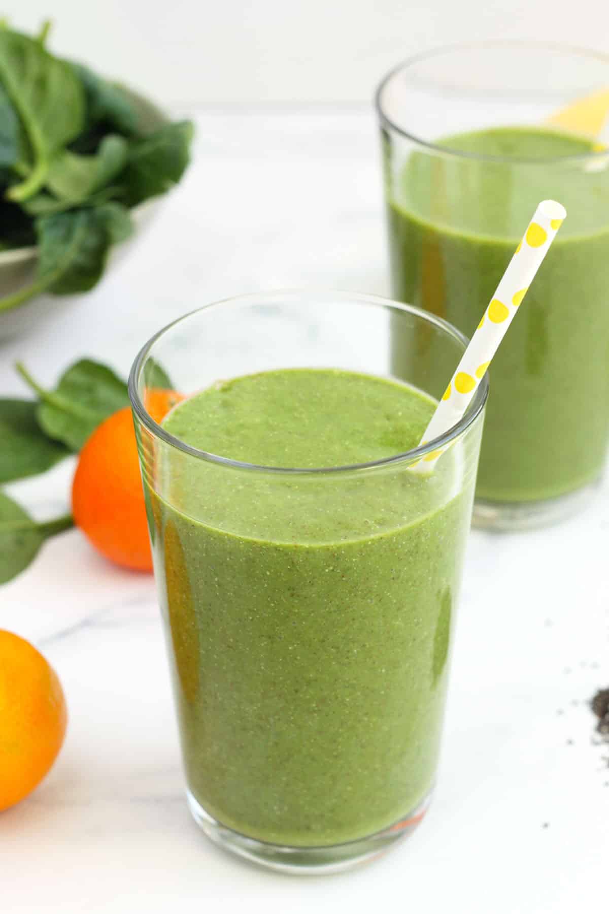 The Best Green Smoothie 5 green smoothie in a clear glass with a yellow polka dot straw