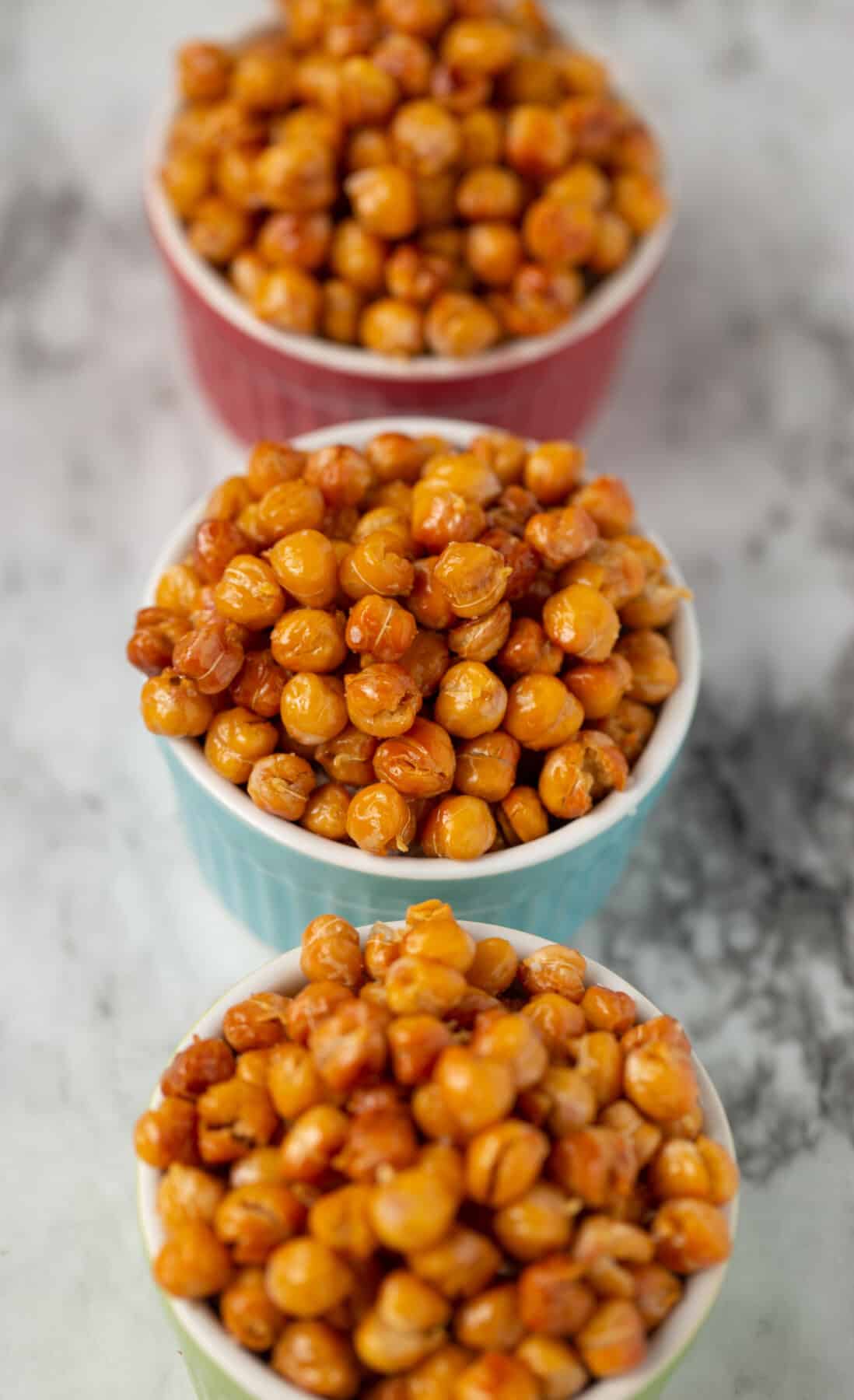 roasted chickpeas in 3 different colored bowls