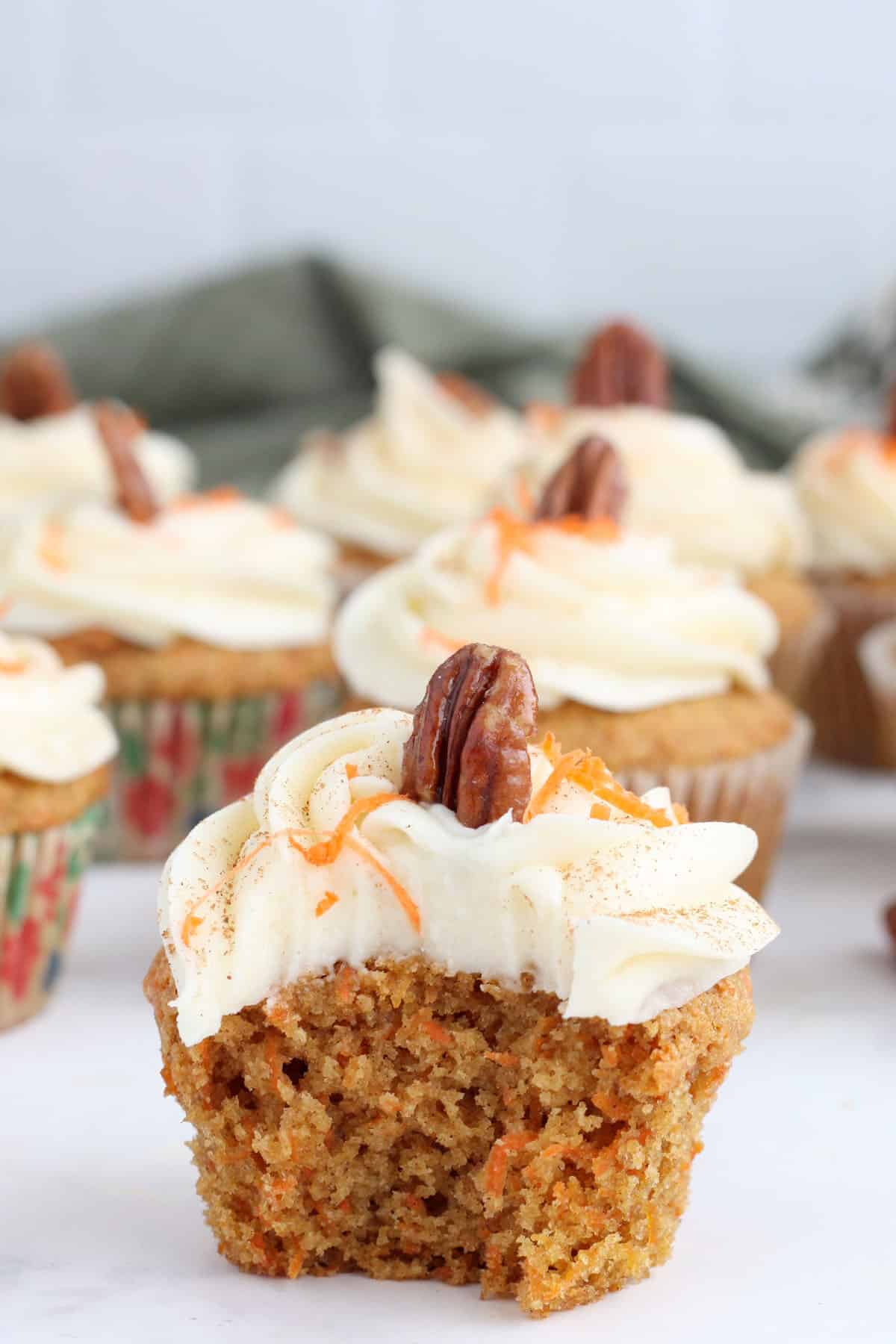 carrot cake cupcake with a bite taken out
