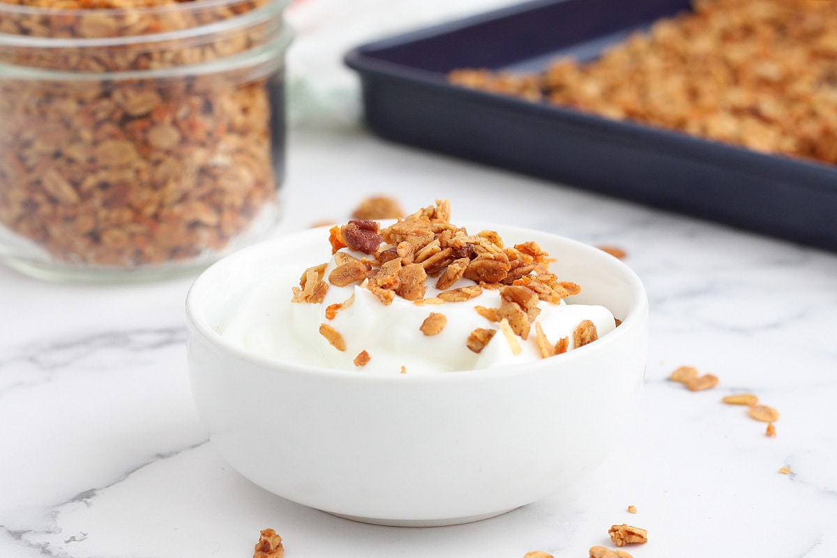 a bowl of yogurt with carrot cake granola