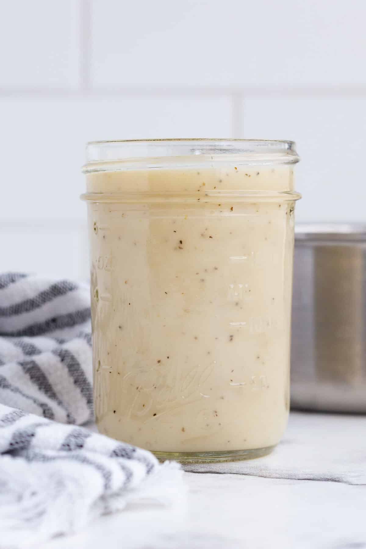 Glass mason jar with homemade creamy chicken soup