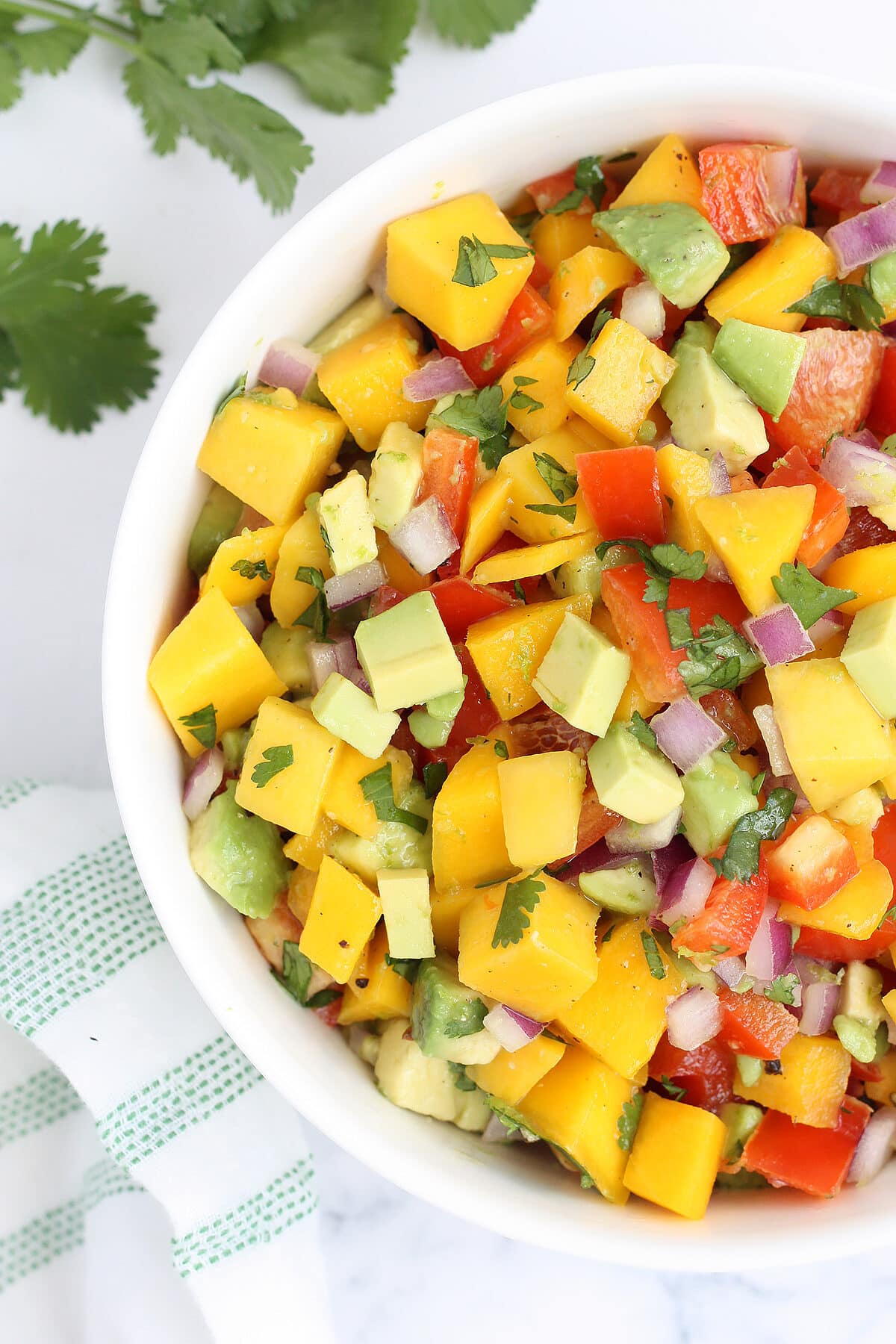 fresh mango and avocado salsa in a white bowl