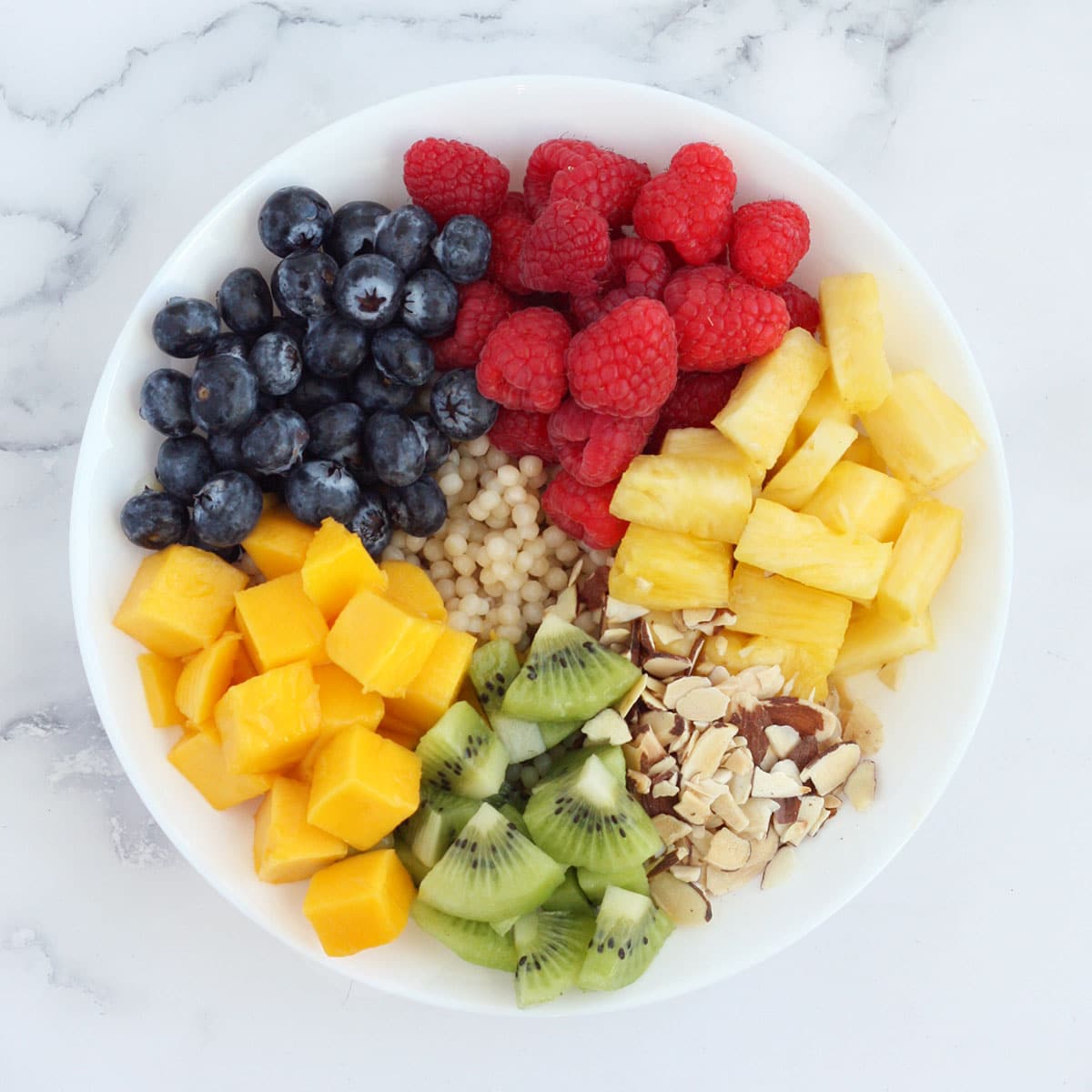 a process shot of how to make the best fruit salad