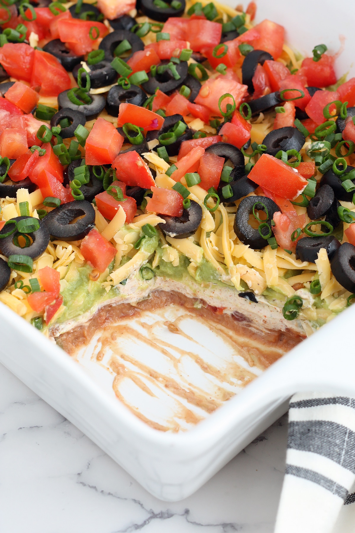 Close-up of a 7-layer dip with the scoop removed
