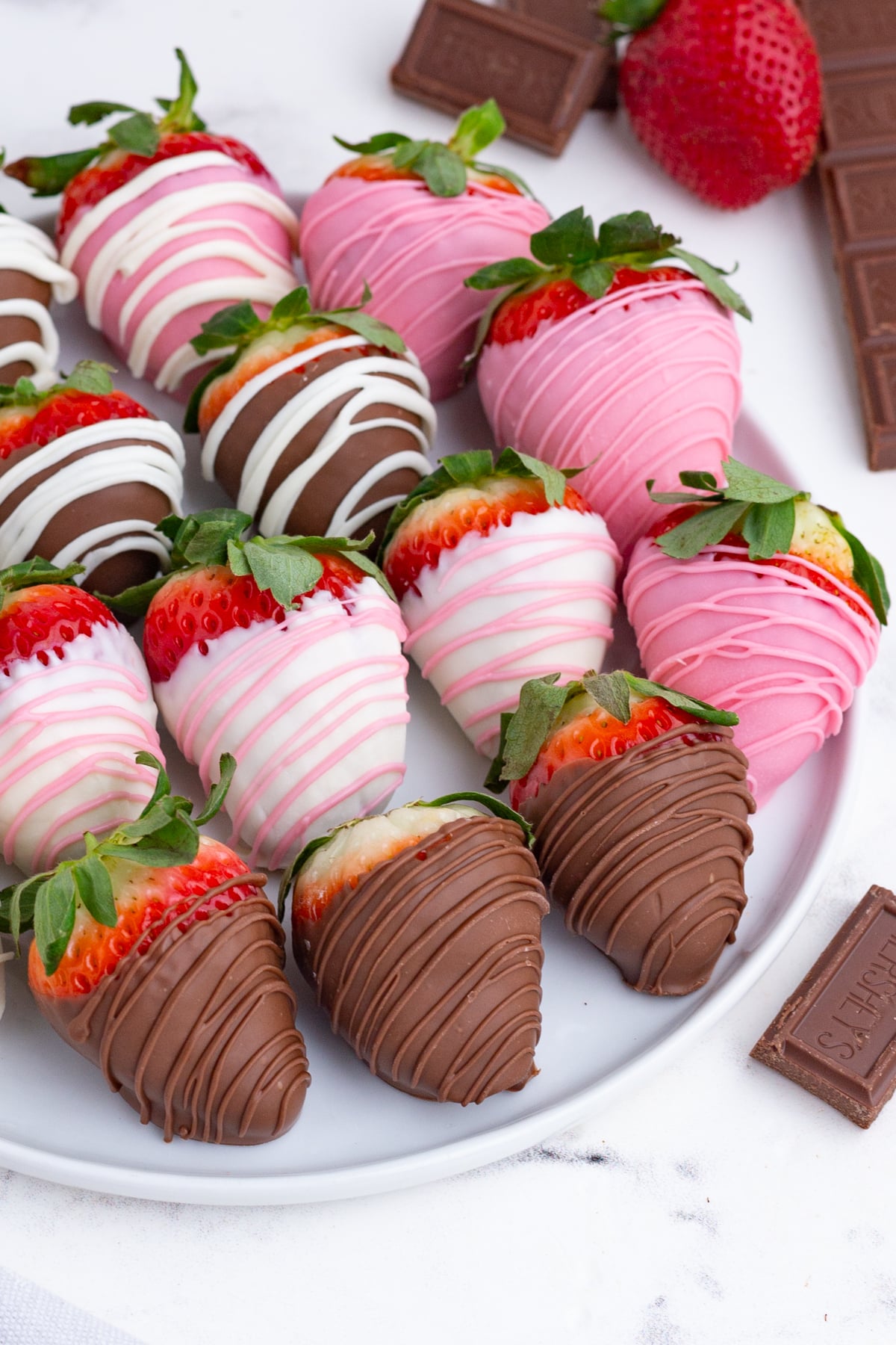 strawberries dipped in chocolate on a serving plate