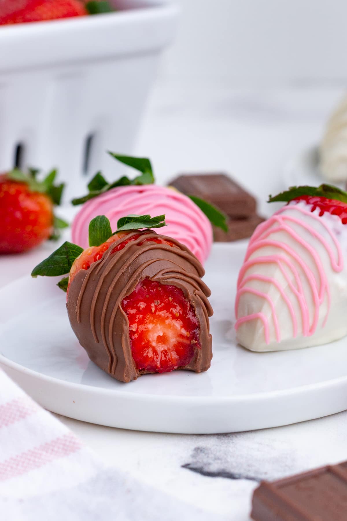 a chocolate covered strawberry with a bite taken out