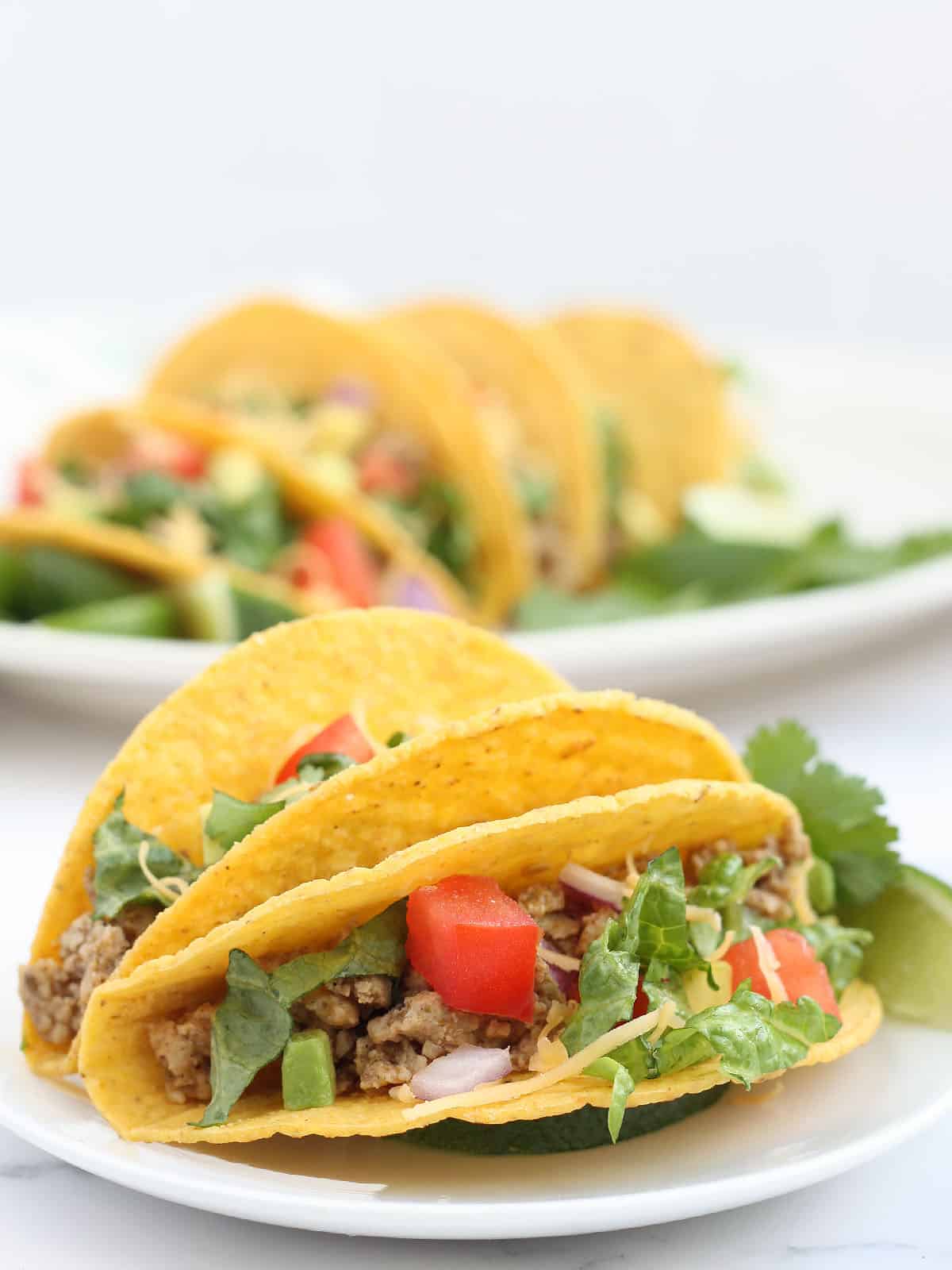 Close-up shot of ground turkey tacos on a serving plate