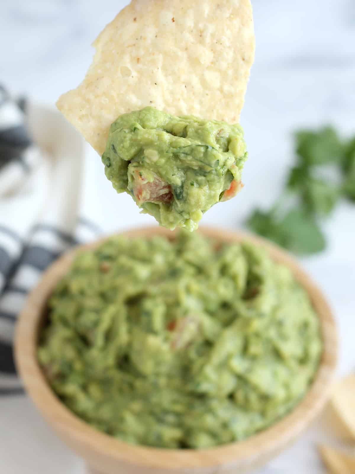 Scoop of guacamole on tortilla chips