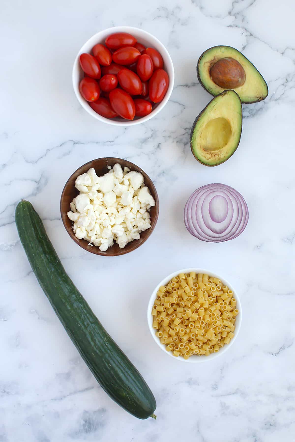 Ingredients needed to make avocado pasta salad.