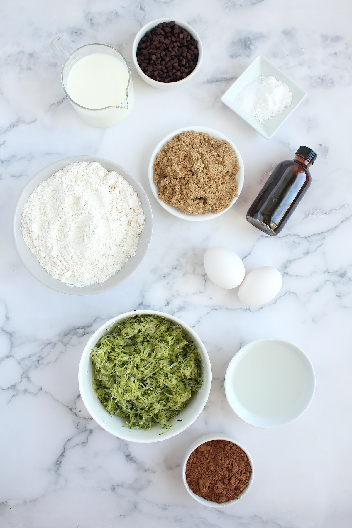 Ingredients needed to make chocolate zucchini muffins.