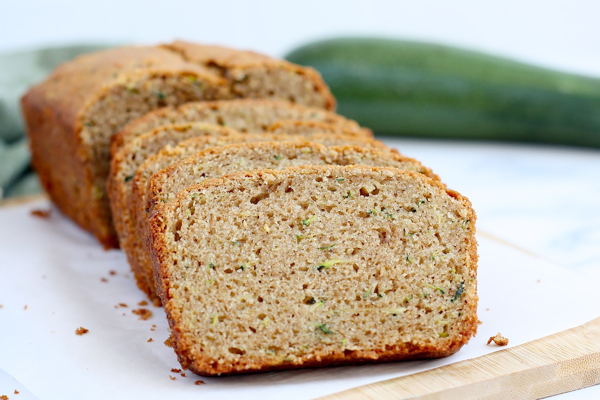 Thick slices of zucchini bread on white parchment paper.