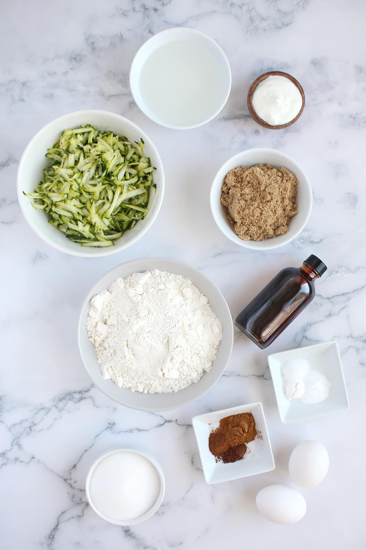 Ingredients you need to make zucchini muffins.