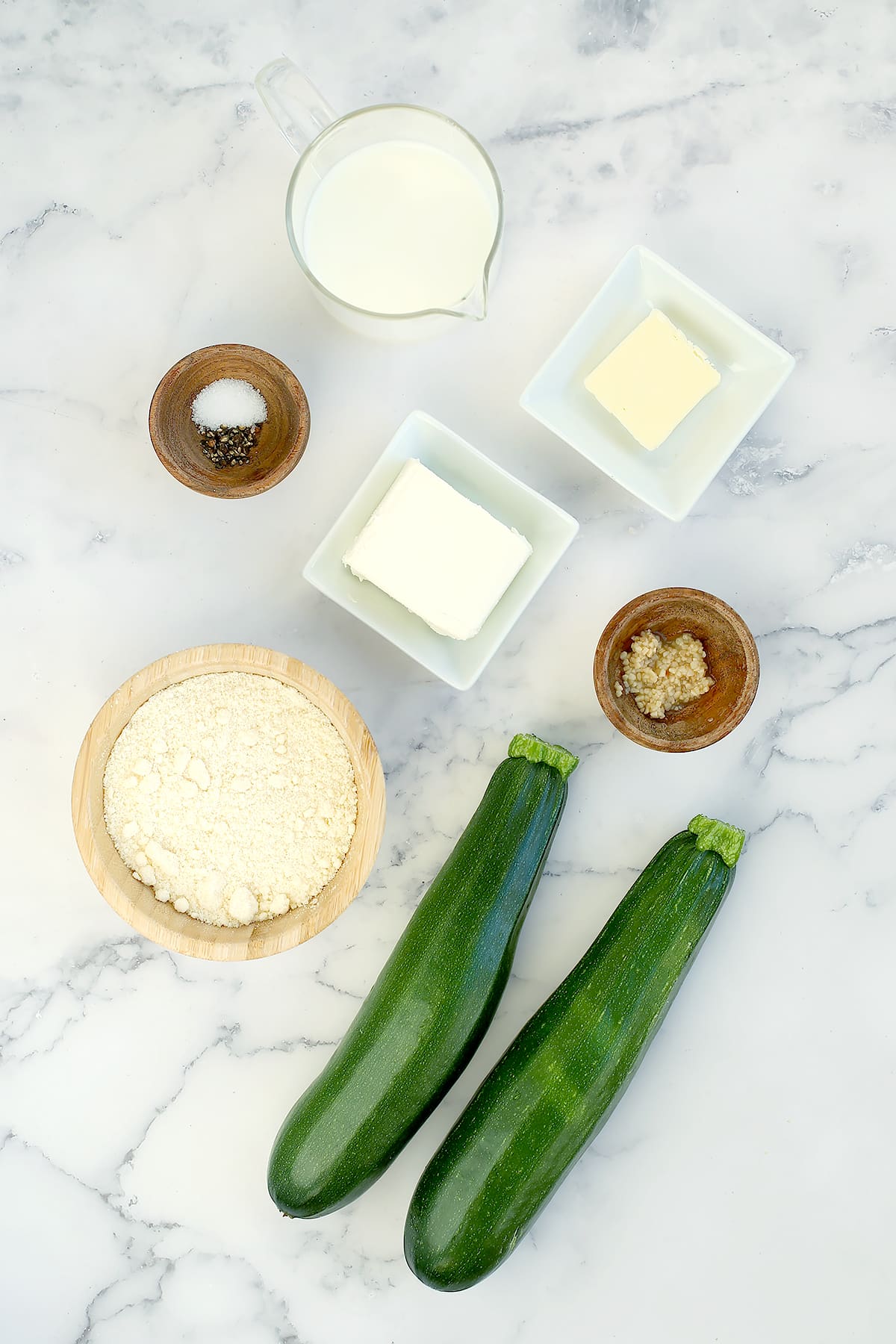 Ingredients needed to make homemade zucchini noodles with alfredo sauce.