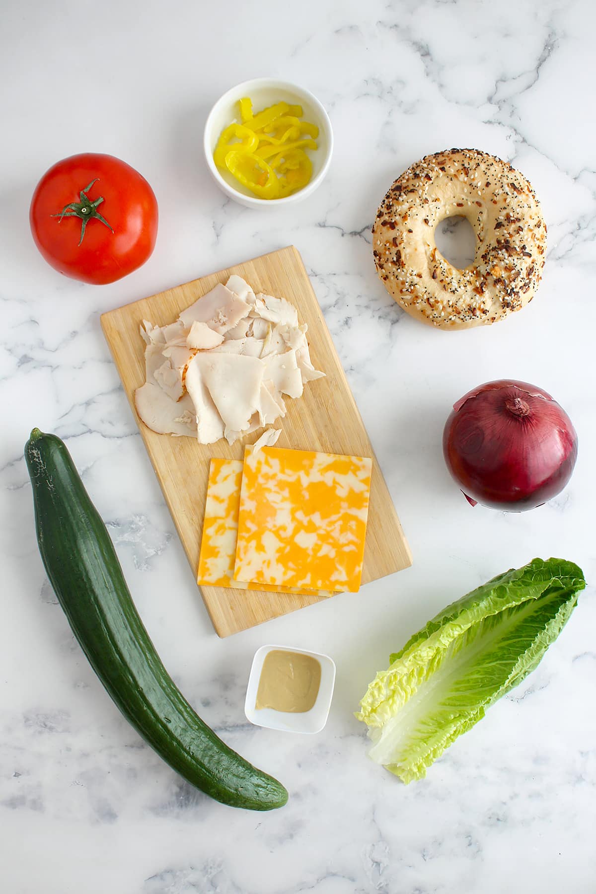 Ingredients needed to make turkey bagel sandwiches.