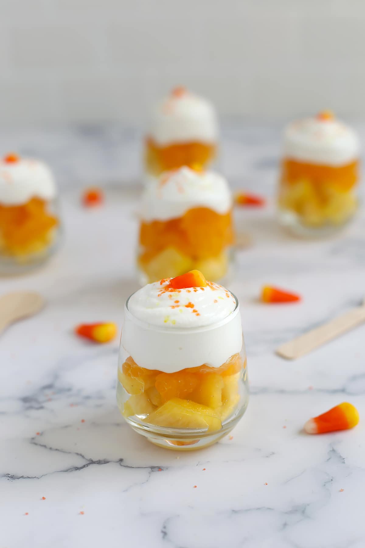 Healthy halloween fruit parfaits made with pineapple, oranges, and cottage cheese.