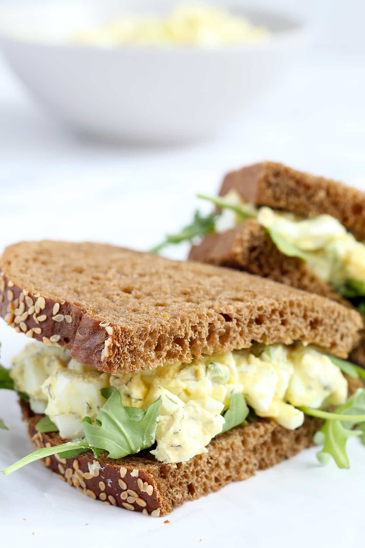 Homemade egg salad sandwich with arugula on rye bread. 