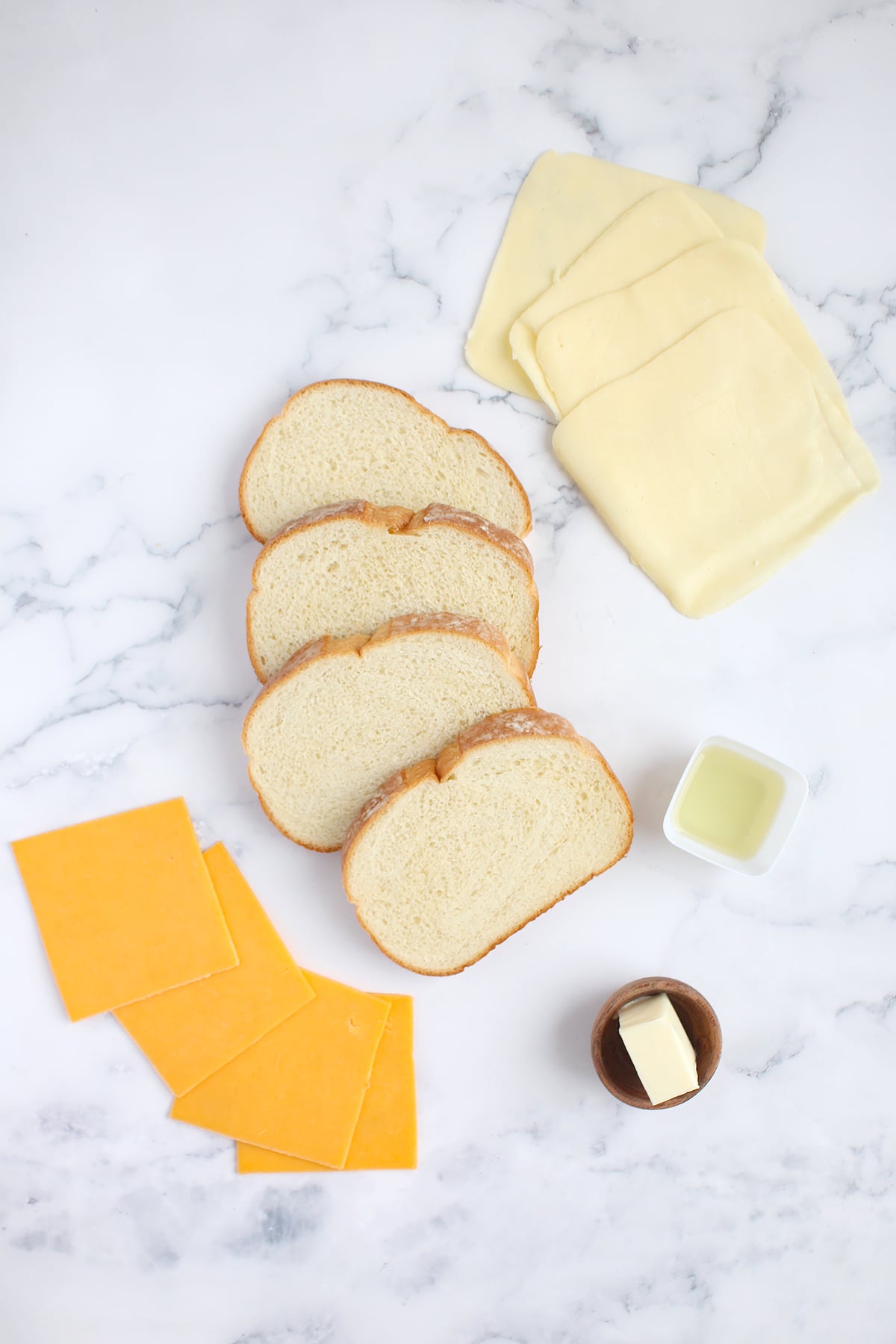 Ingredients needed to make the gooiest grilled cheese sandwich.