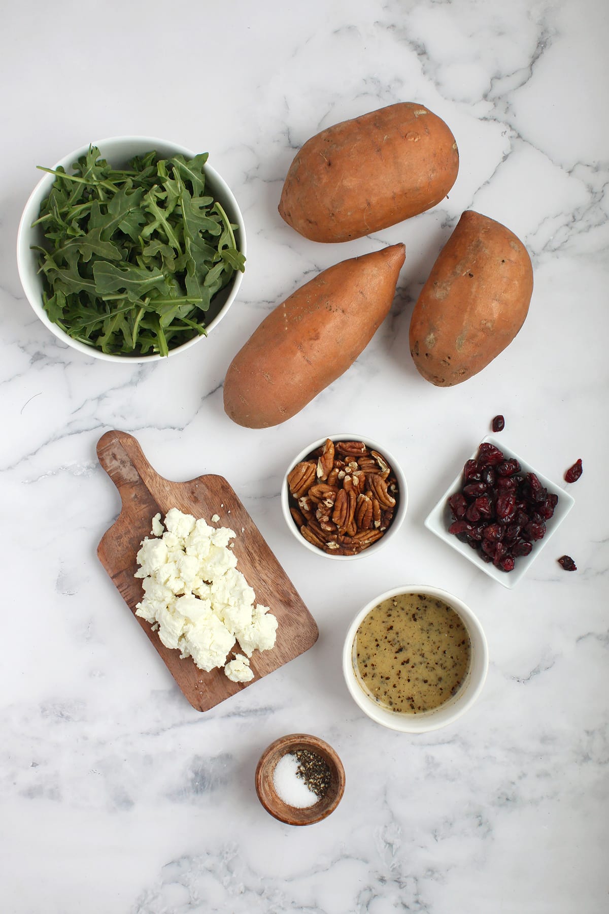 Ingredients needed to make sweet potato salad with arugula and goat cheese.