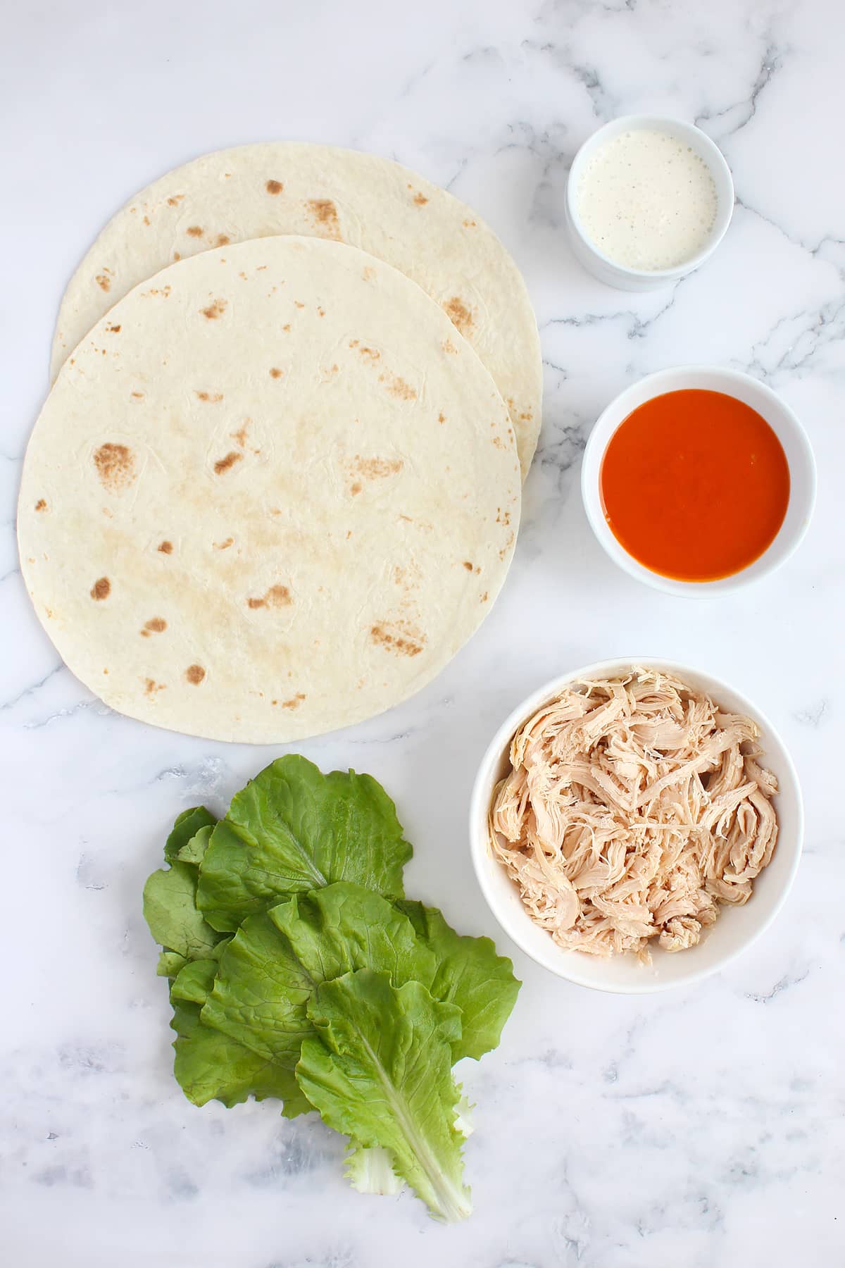 Ingredients you need to make buffalo chicken wraps.